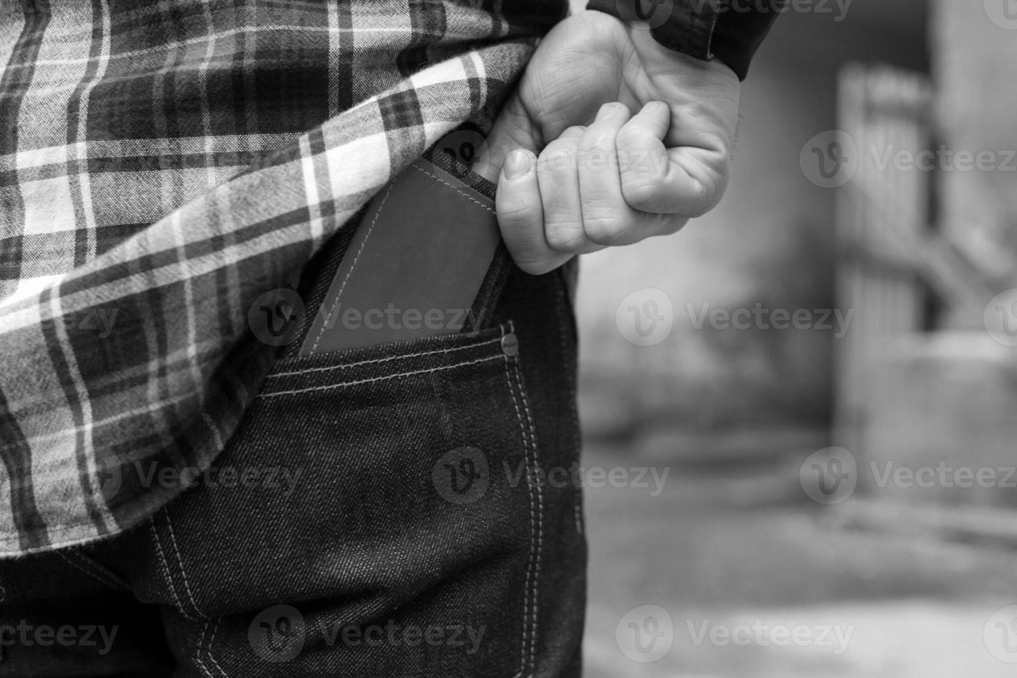 the man took out his wallet from selvedge jeans with place for a sign photo