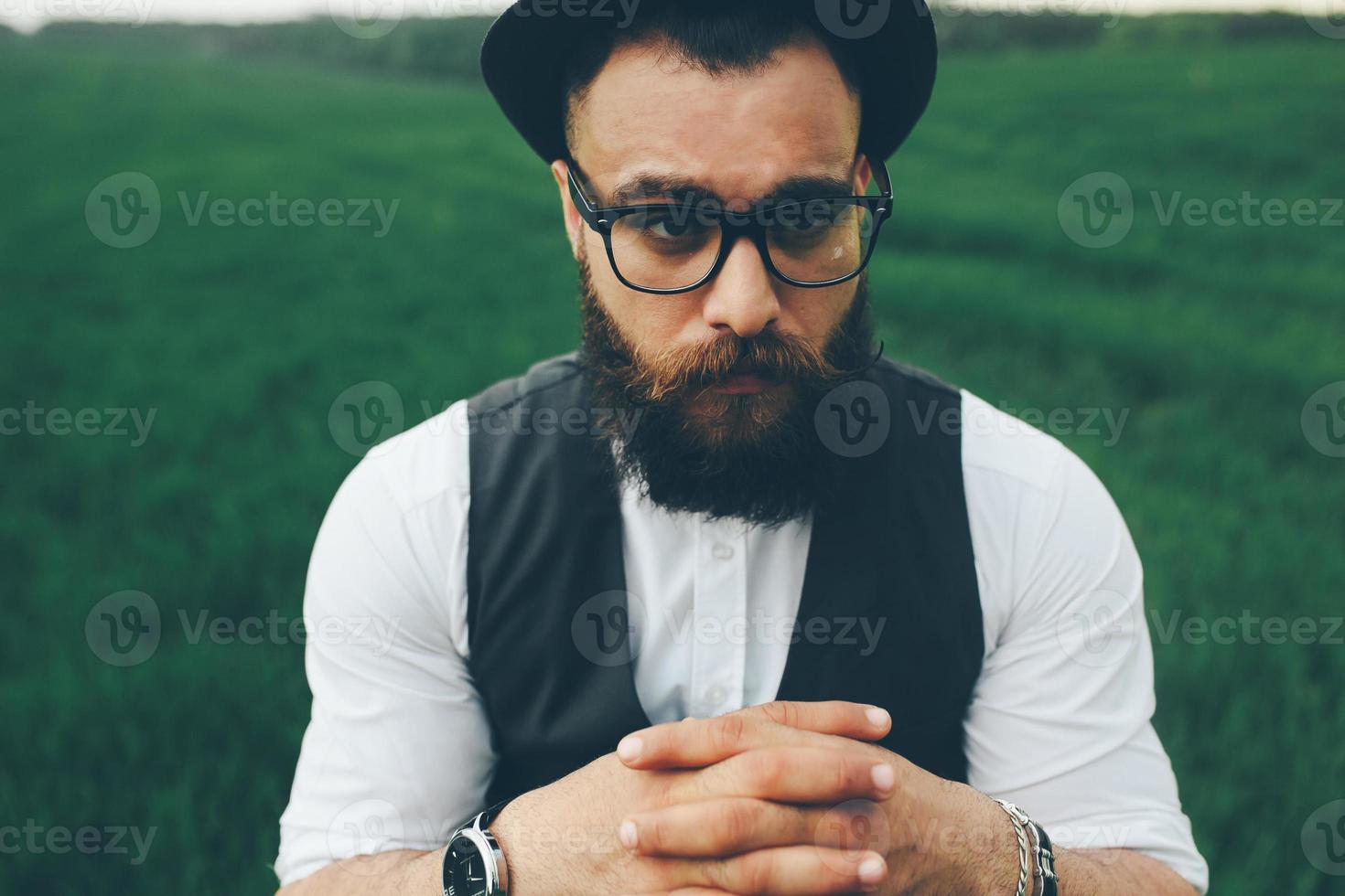 man with a beard, thinking in the field photo