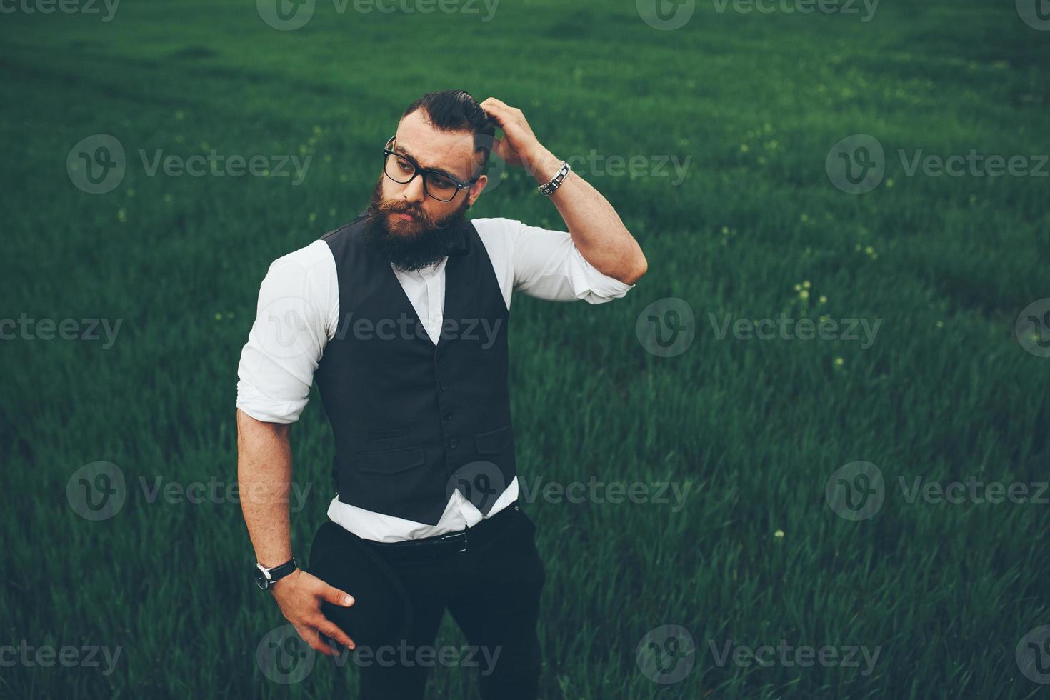 man with a beard, thinking in the field photo