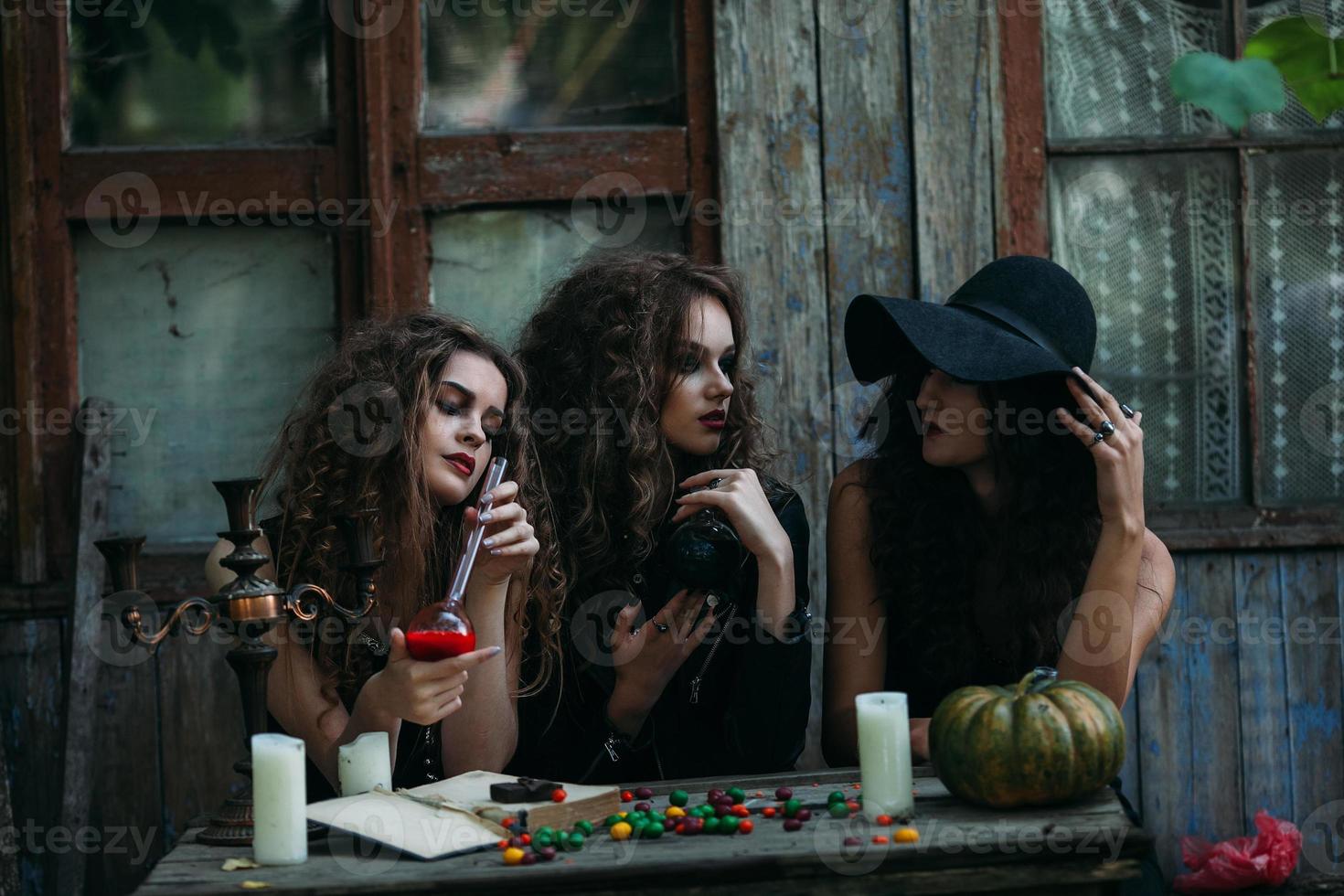 Three vintage witches perform magic ritual photo