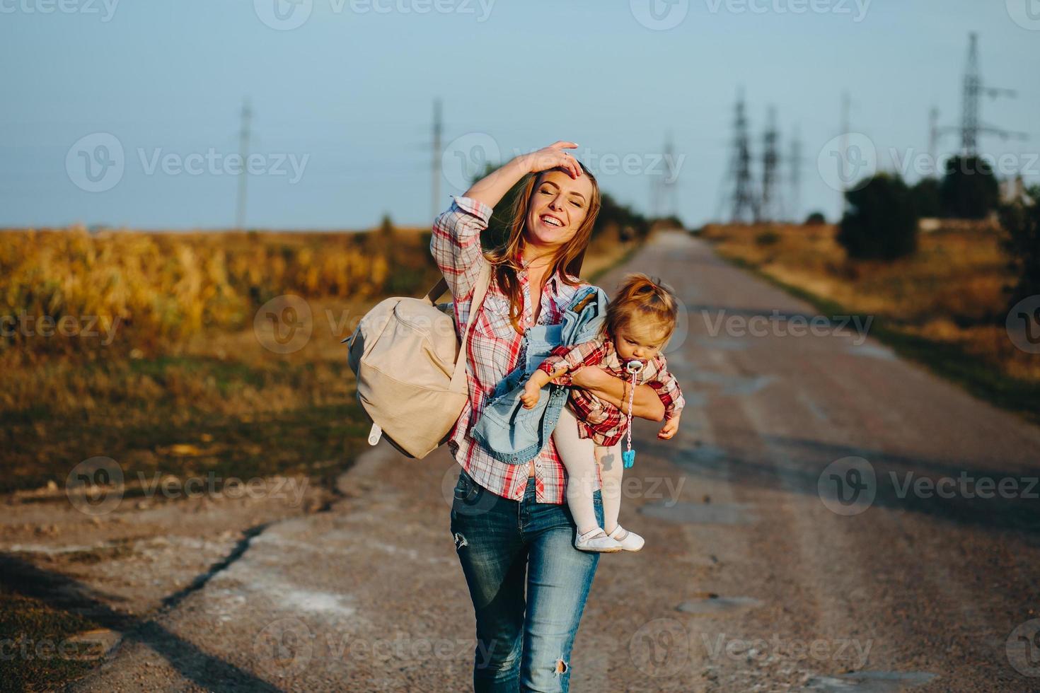 mother and daughter on a field with pumpkins photo