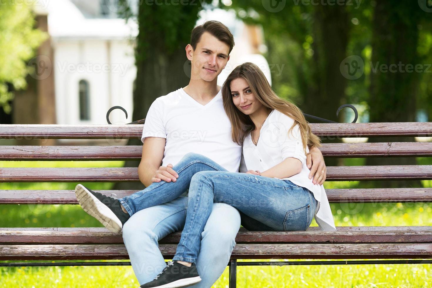 man and woman on a bench in the park photo