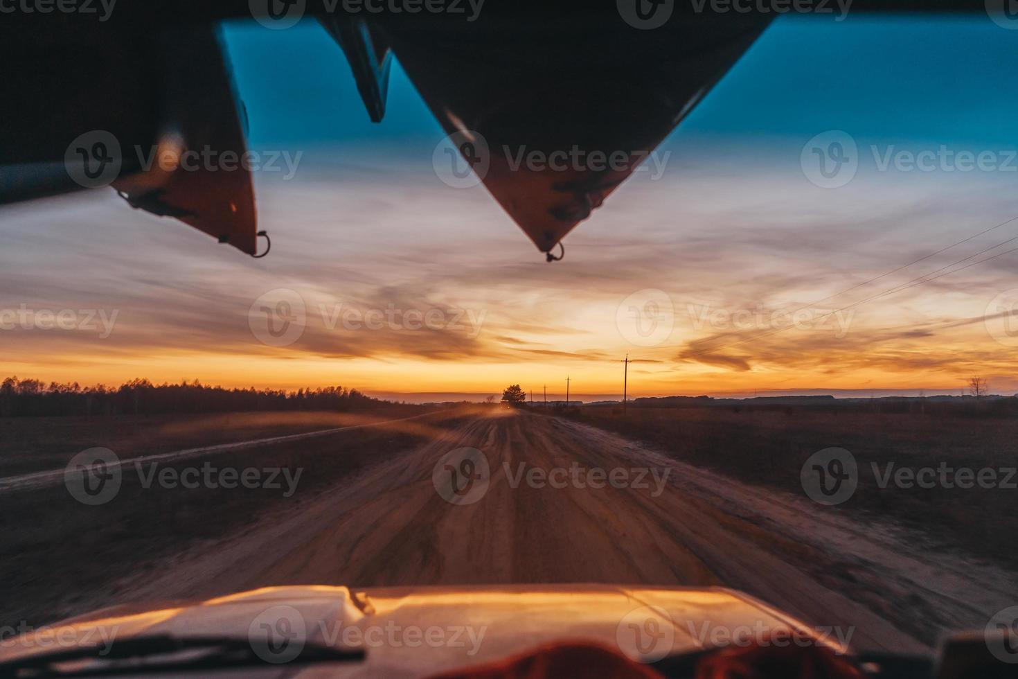 SUV driving on a dirt road view through the windshield photo