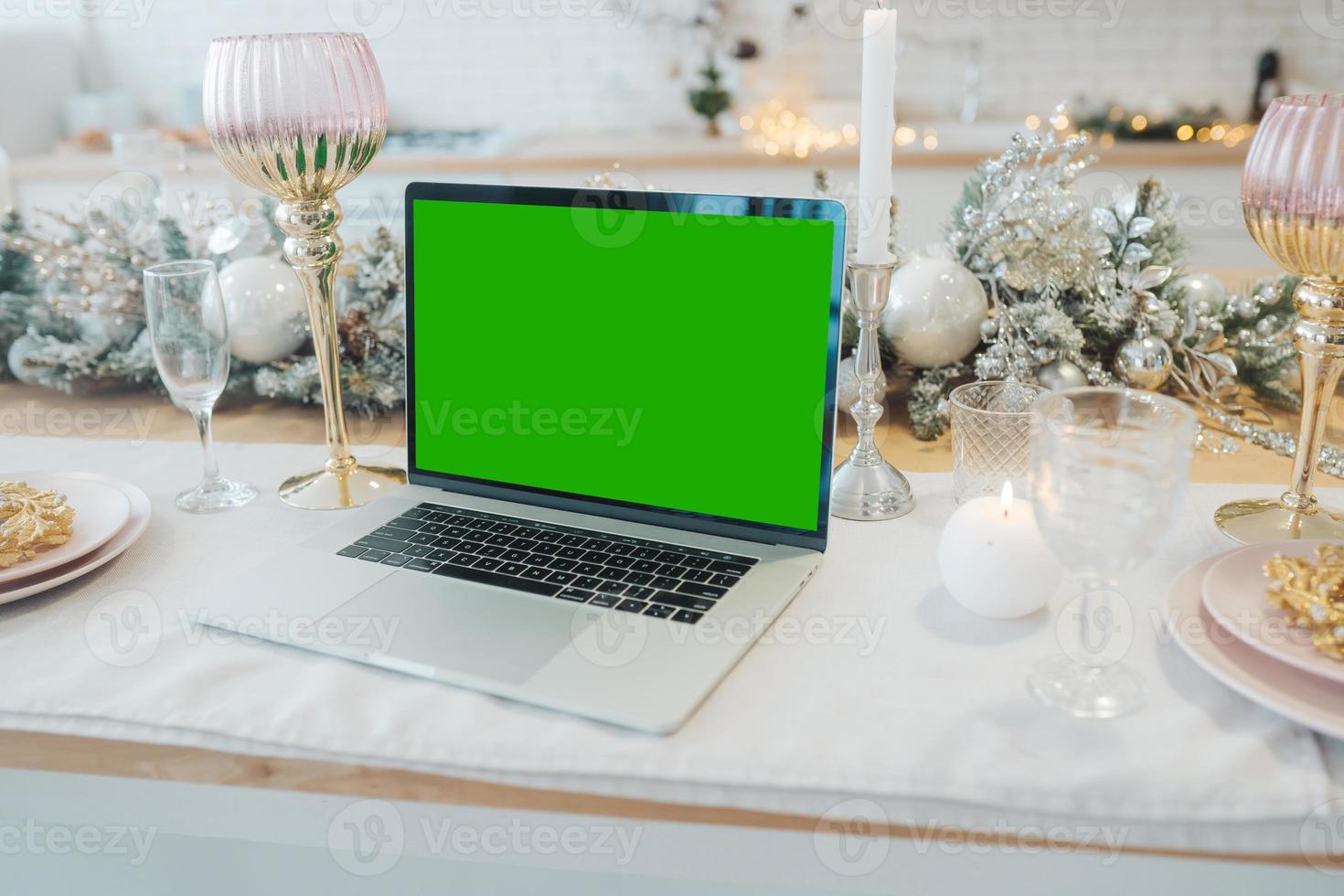 laptop with green screen - chromakey near New Year's decorations. christmas theme. photo