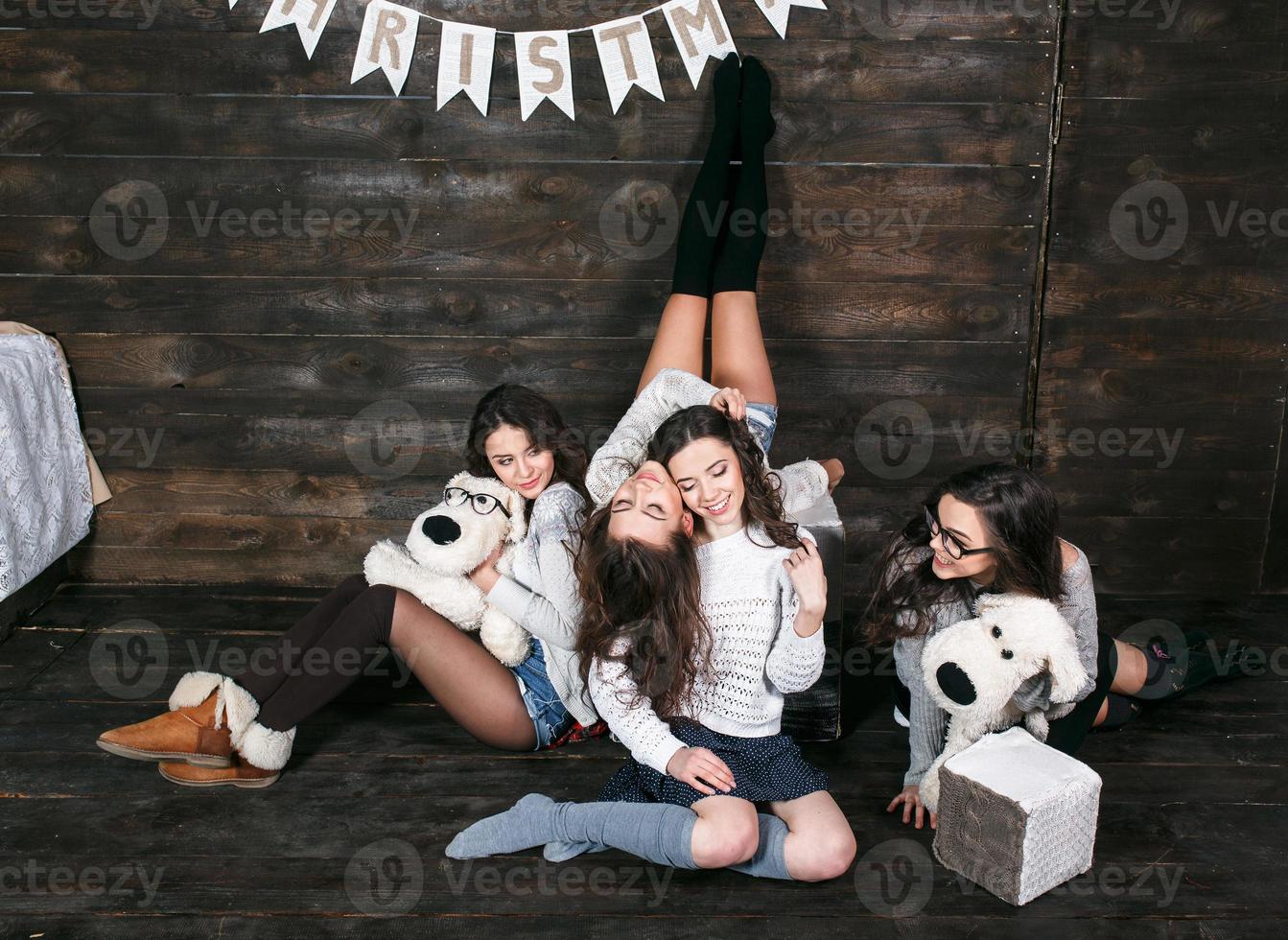 Four charming model posing on a vintage New Year's background photo