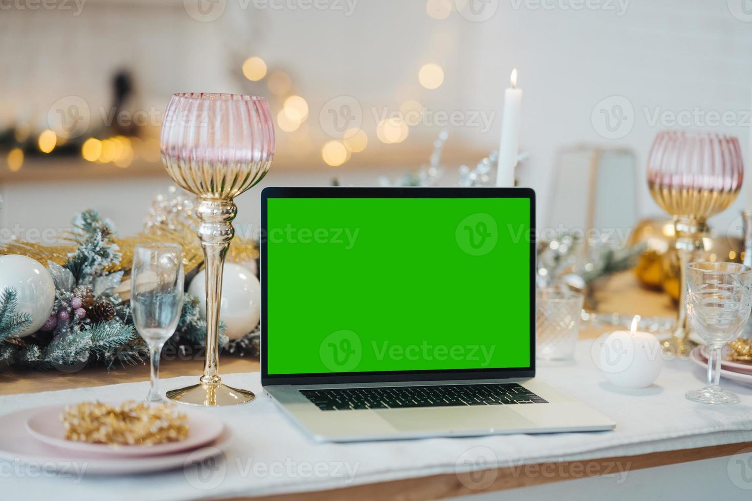 laptop with green screen - chromakey near New Year's decorations. christmas theme. photo