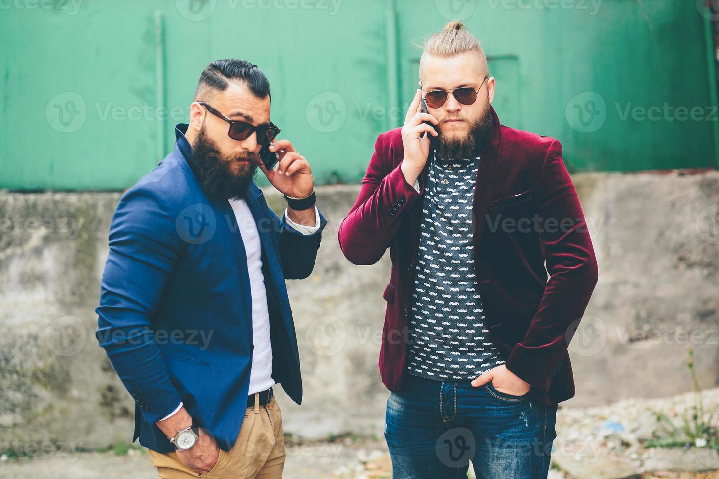 Two bearded businessman looking at phone photo