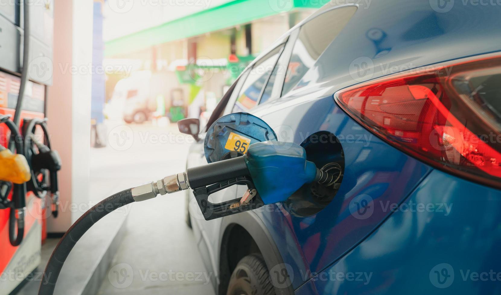 Car fueling at gas station. Refuel fill up with petrol gasoline. Petrol pump filling fuel nozzle in fuel tank of car at gas station. Petrol industry and service. Petrol price and oil crisis concept. photo