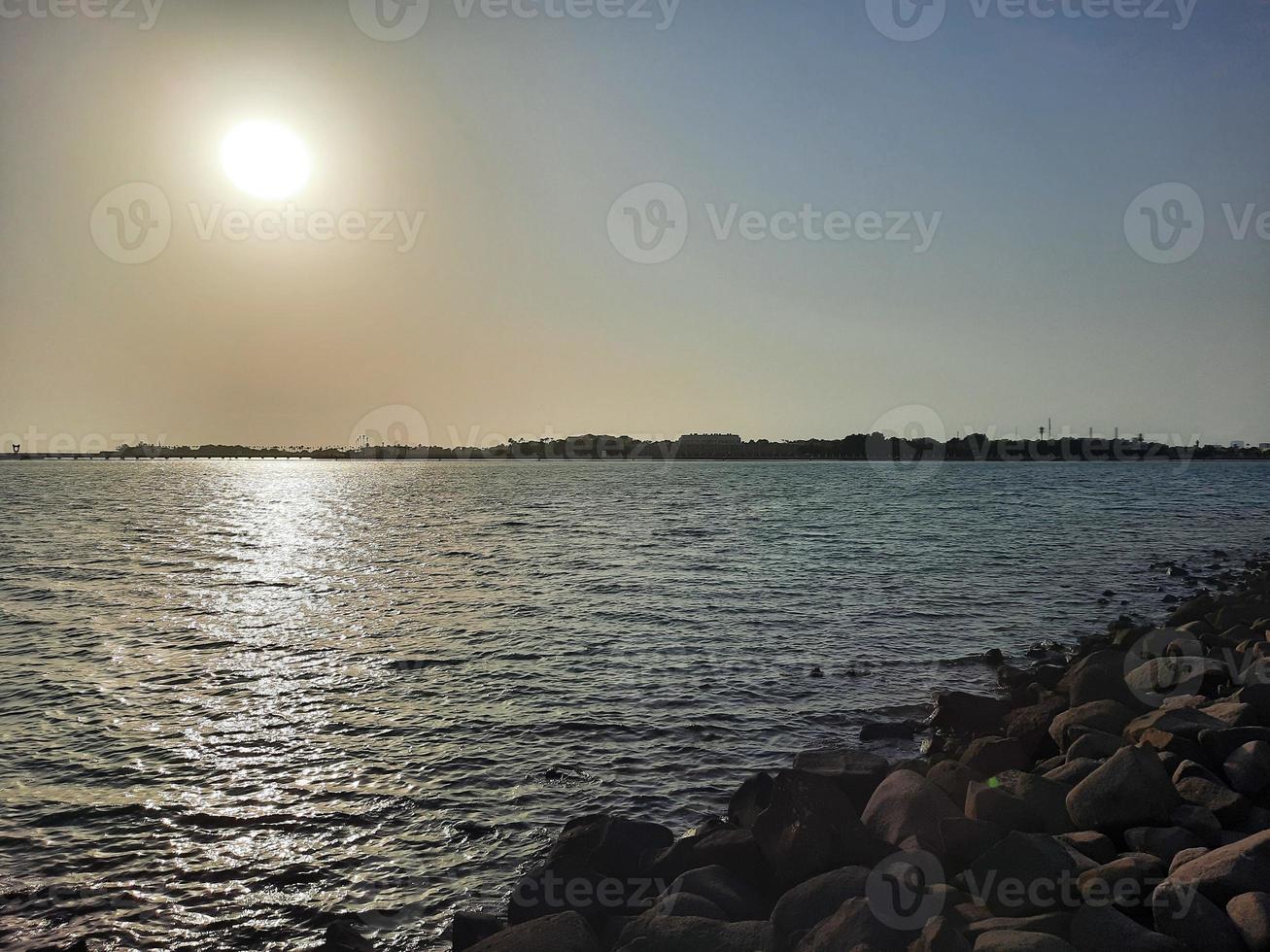 Beautiful sunset at Jeddah, Corniche. The Jeddah Corniche, also known as the Jeddah Waterfront, is a coastal area of the city of Jeddah, Saudi Arabia. Located along the Red Sea. photo