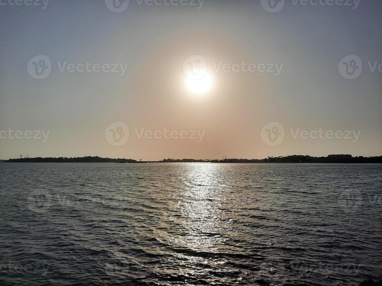 Beautiful sunset at Jeddah, Corniche. The Jeddah Corniche, also known as the Jeddah Waterfront, is a coastal area of the city of Jeddah, Saudi Arabia. Located along the Red Sea. photo