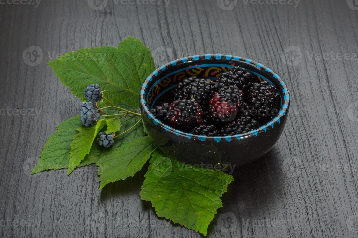 Blackberry in a bowl on wooden background photo