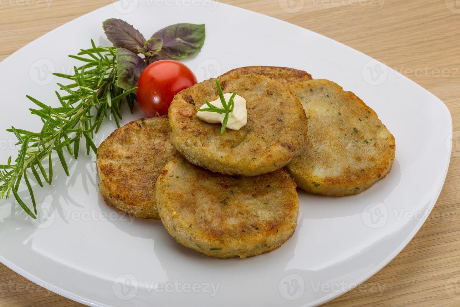 Hash brown on the plate and wooden background photo