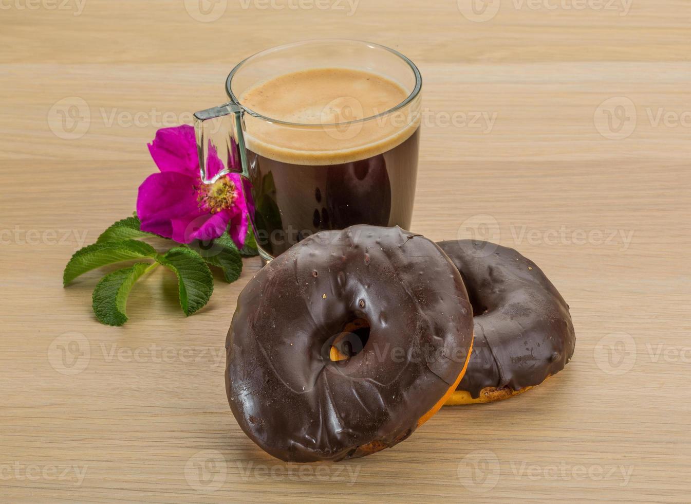 Coffee with Chocolate donuts on wooden background photo