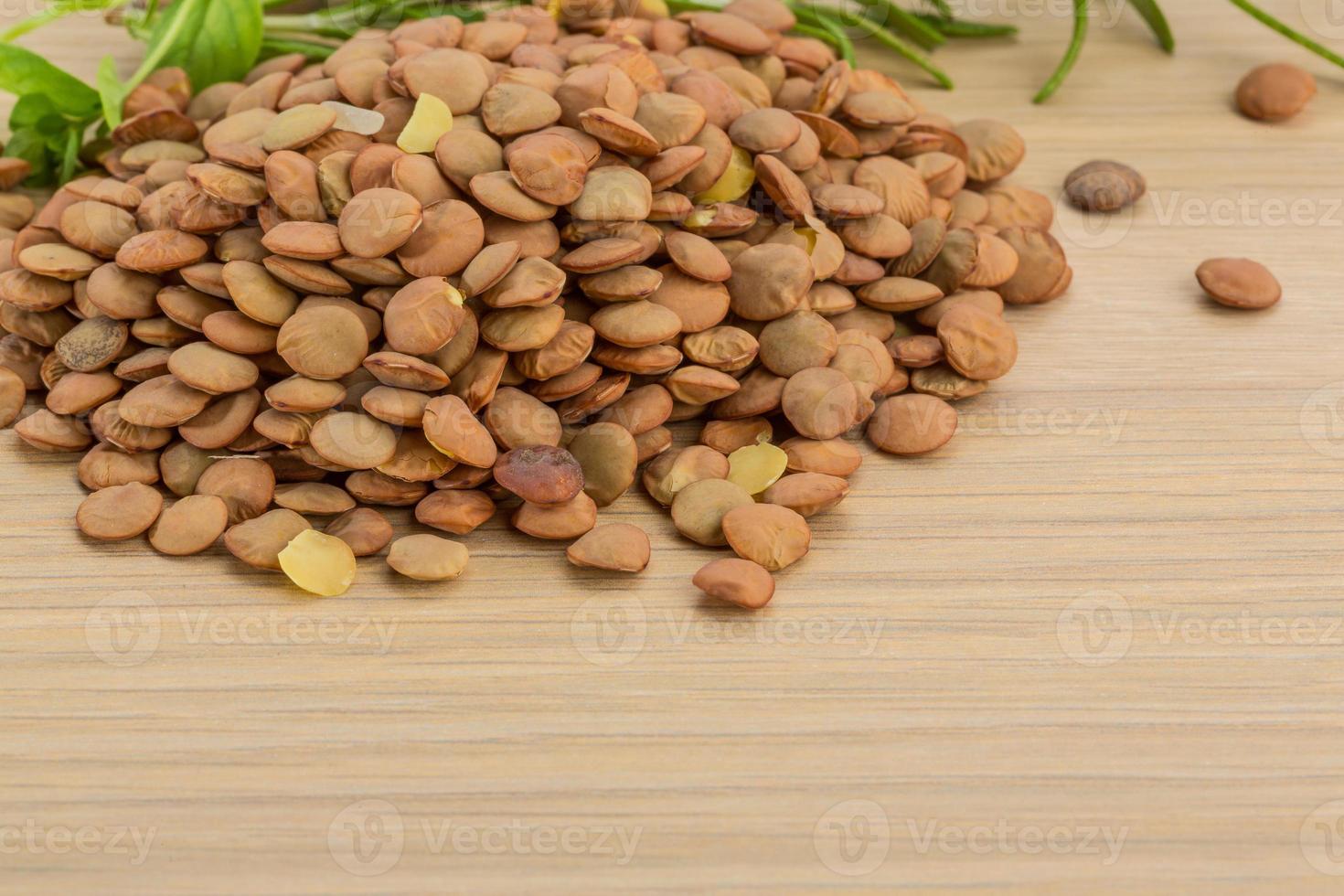 Raw lentils on wooden background photo