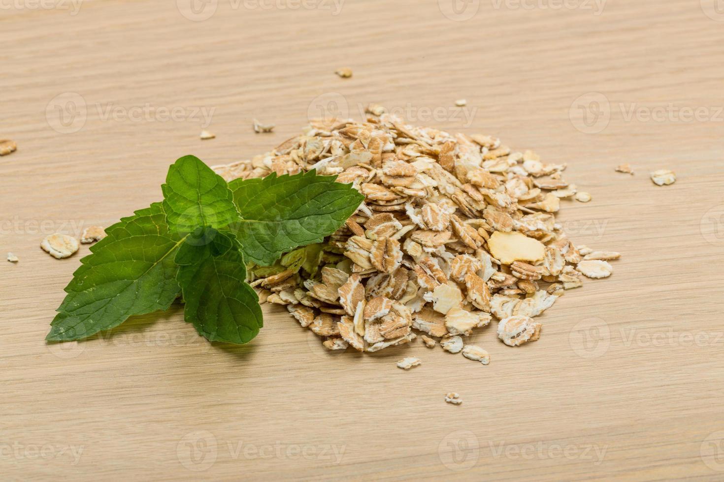 Oats on wooden background photo