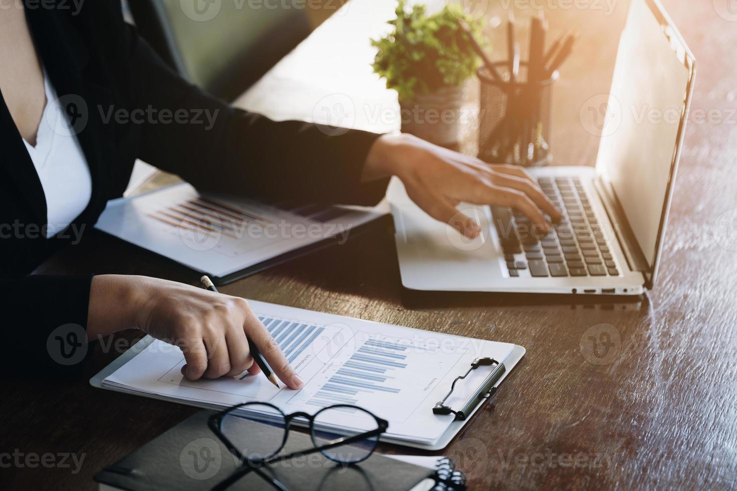 Investment concepts, businesswomen use document and computers to analyze stock markets, quantitative data collection, financial statement analysis, profitability through internet technology. photo