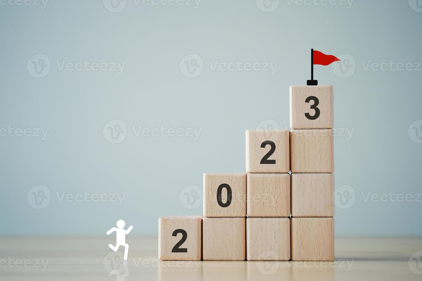 2023 new year challenge goal and target, Achievement and business success. Rises up stairs to target. Human improvement. Personal growth. Human icon looking for 2023 on ladder up to goal flag. photo