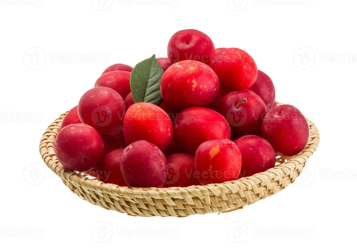 Damson plum in a basket on white background photo