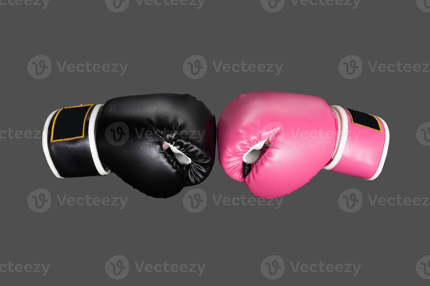 pink and black Boxing glove in punching in woman concept. isolated on dark background. photo