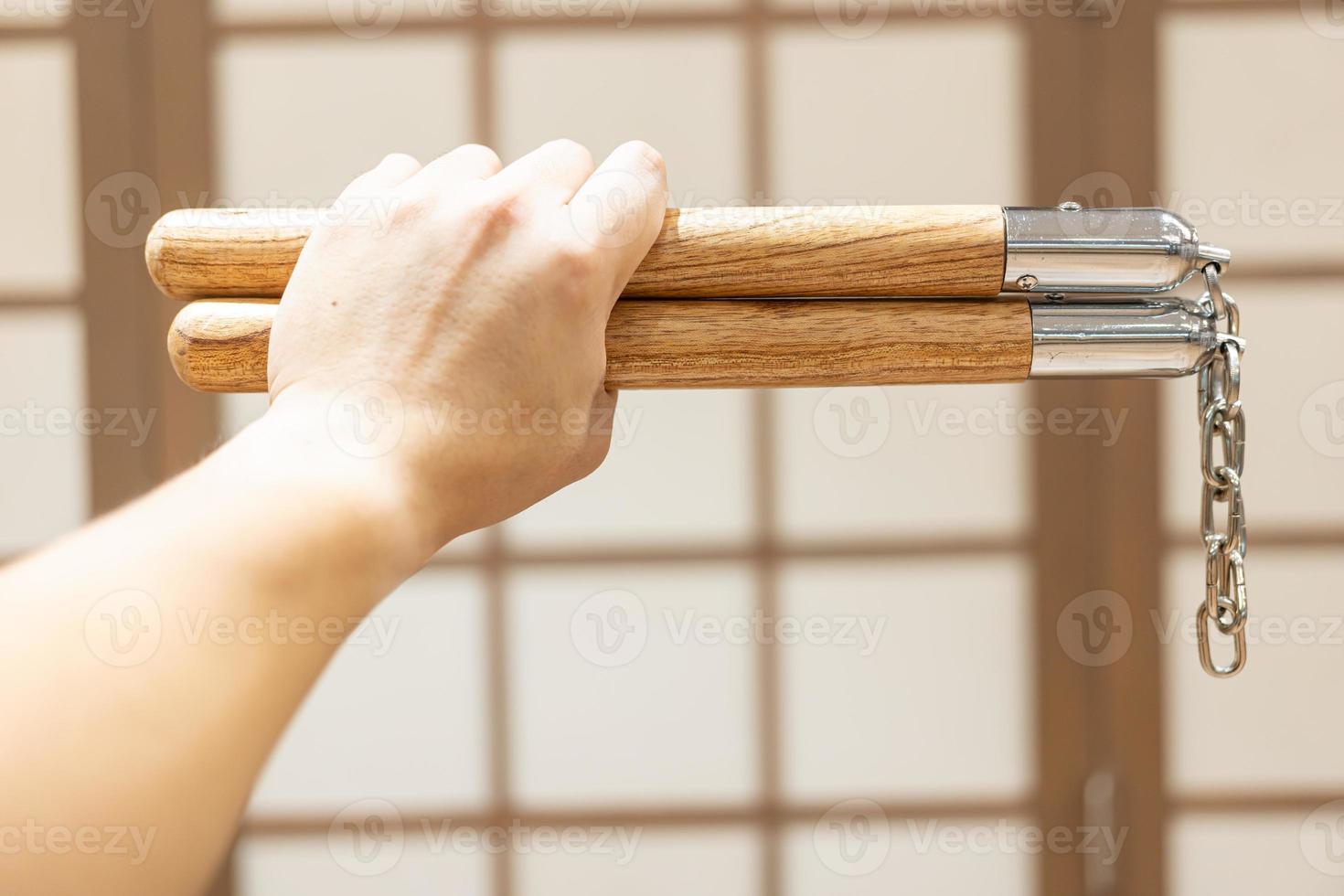 Nunchuks. Wood nunchuks with metal chain. Wooden nunchaku. photo