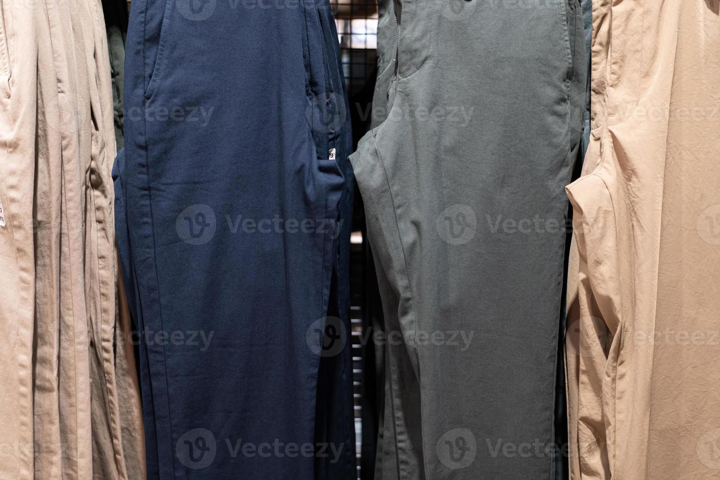 Selective focus, Fashion , clothes concept ,Clothes or pants many colors hang on a shelf in a designer clothes store. Lots of pastel-colored photo