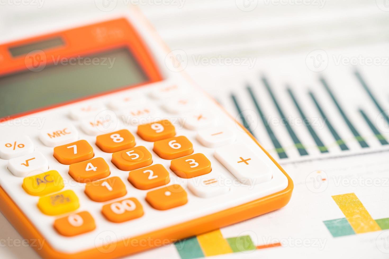 Calculator on charts graphs paper. Financial development, Banking Account, Statistics, Investment Analytic research data economy, Stock exchange trading, Business office concept. photo