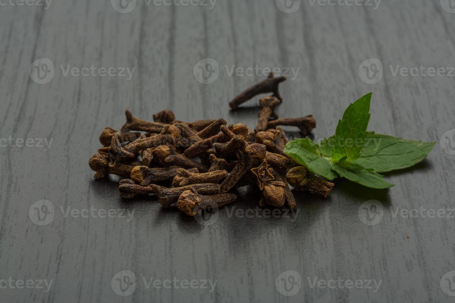 Clove seeds on wooden background photo