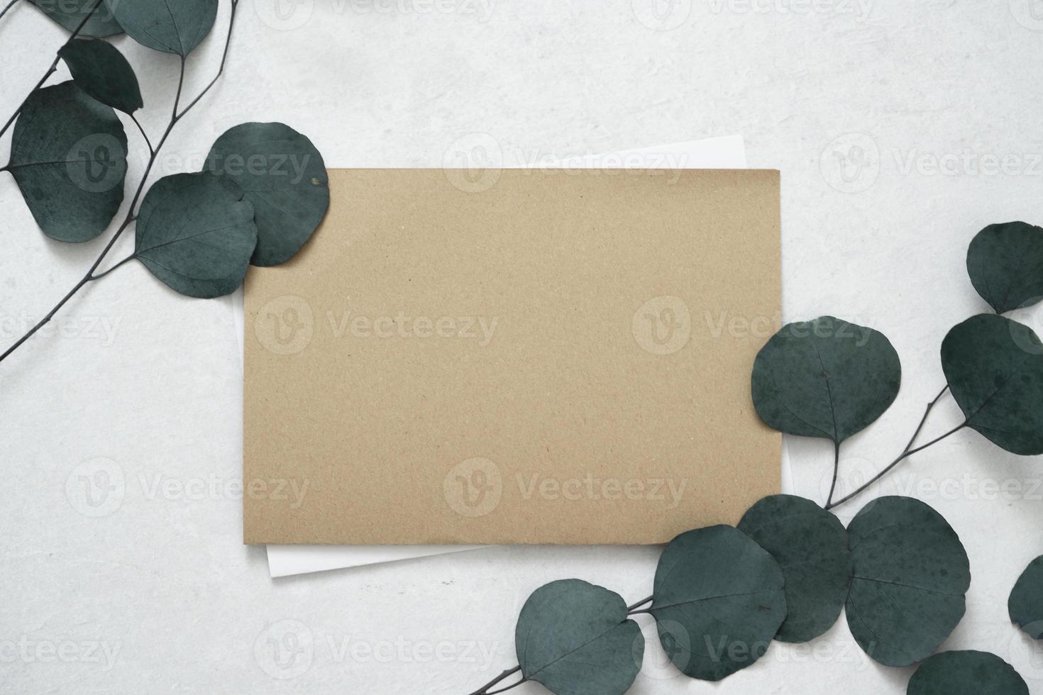 Mockup for a letter or a wedding invitation with leaves eucalyptus branches. photo
