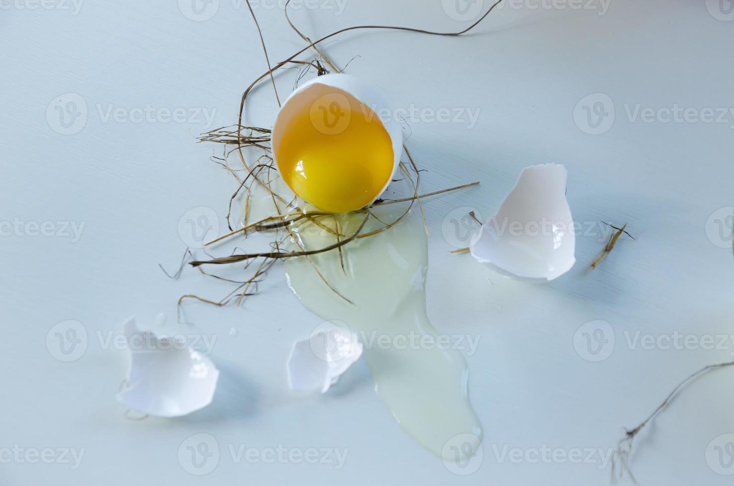 white egg is broken, the shell is on the table. Light background photo