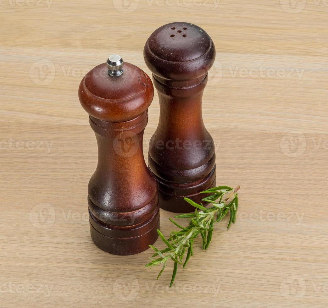 Pepper mill on wooden background photo