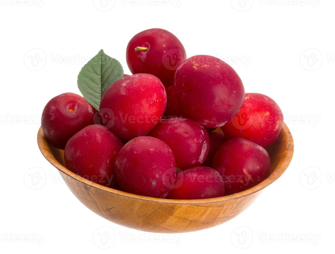 Damson plum in a bowl on white background photo