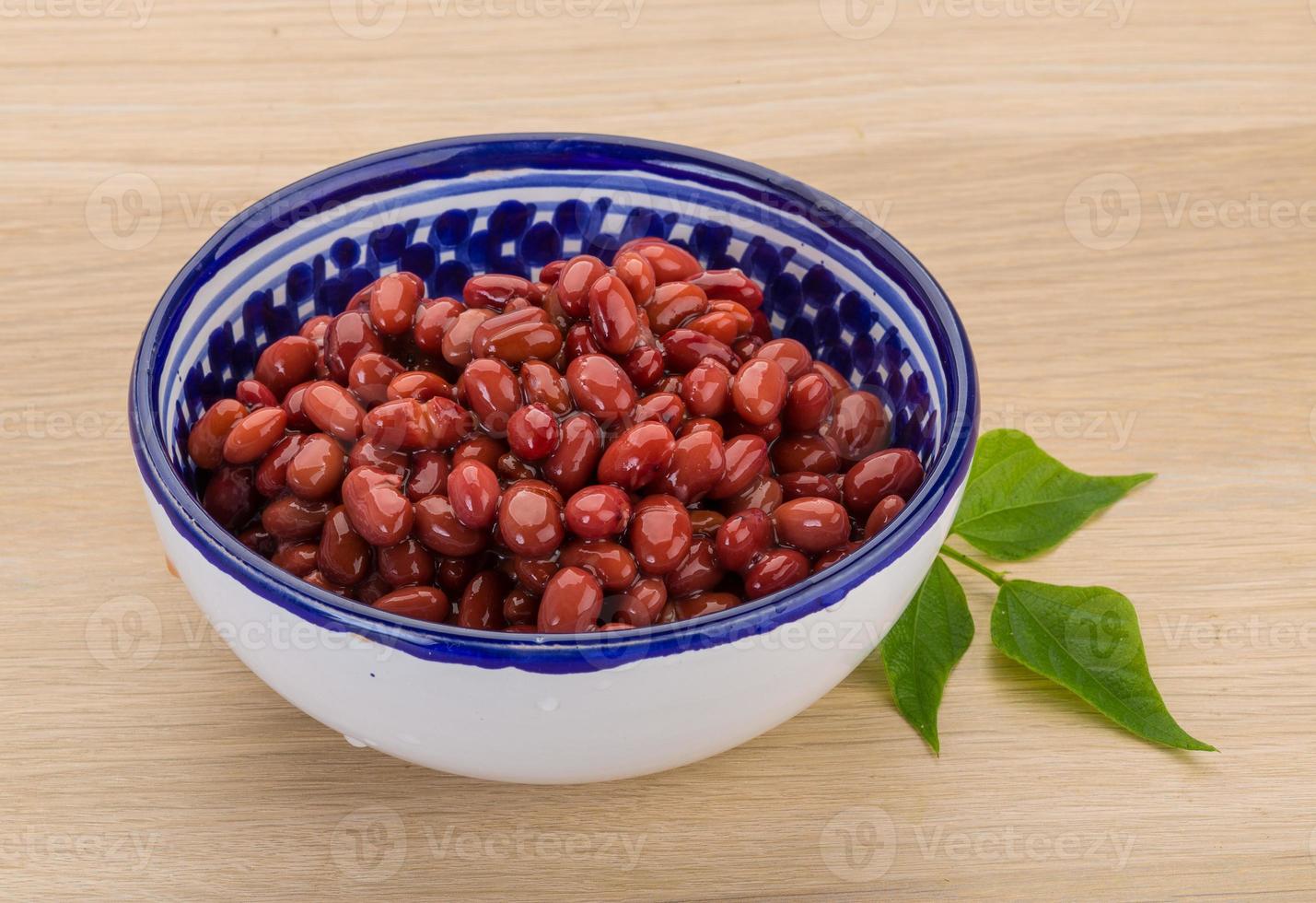 Red beans in a bowl on wooden background photo
