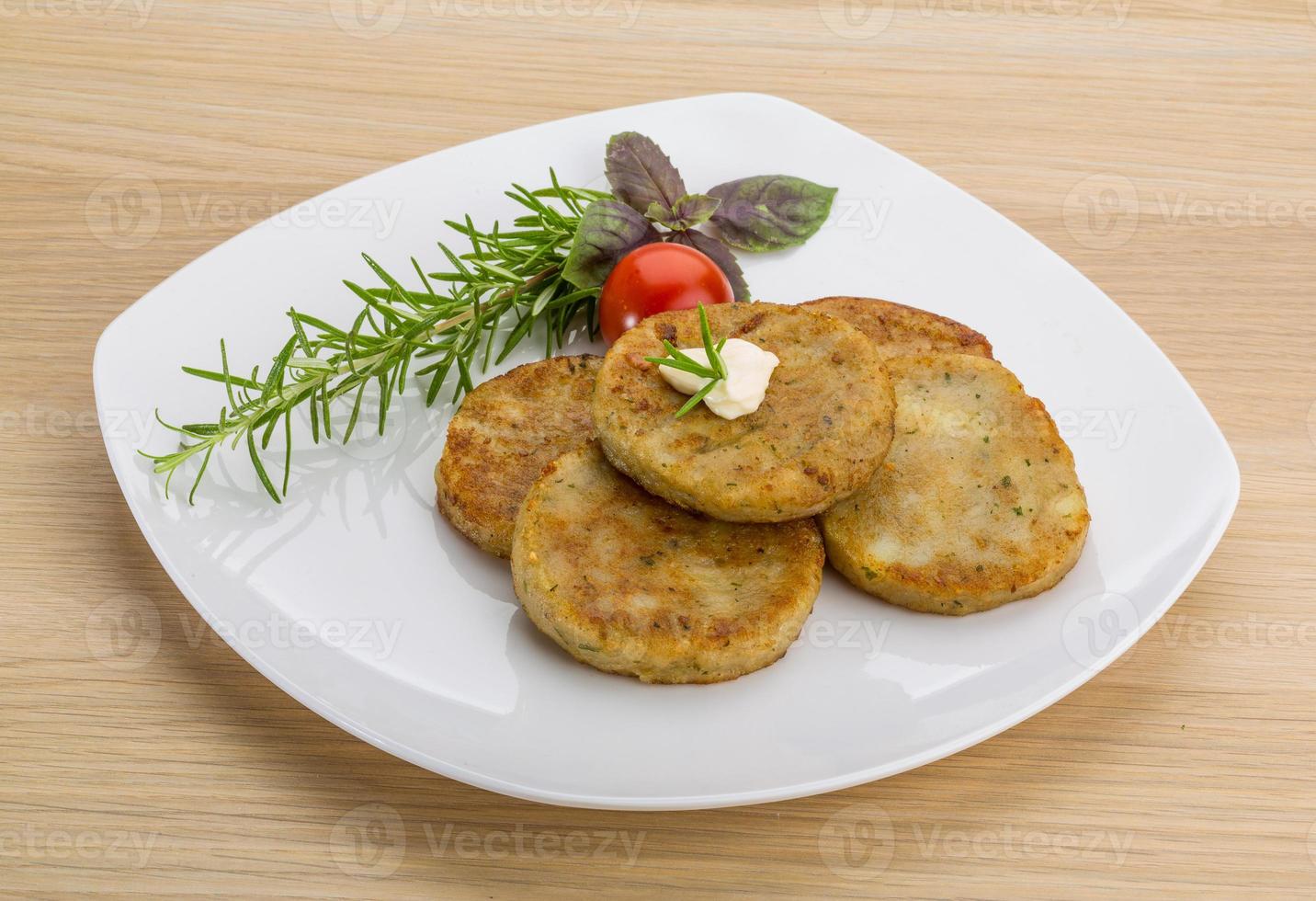 Hash brown on the plate and wooden background photo