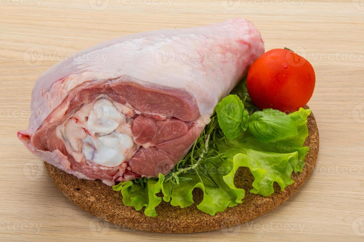 Turkey leg on wooden board and wooden background photo