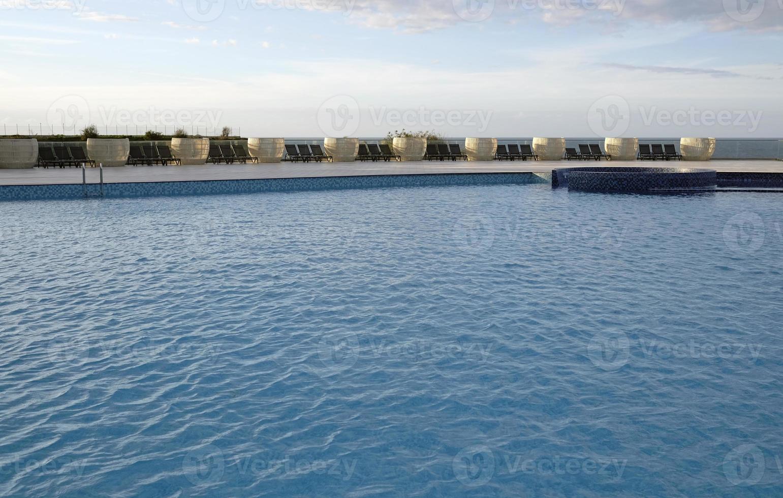 Ripples on the surface of an outdoor pool on a sunny day photo