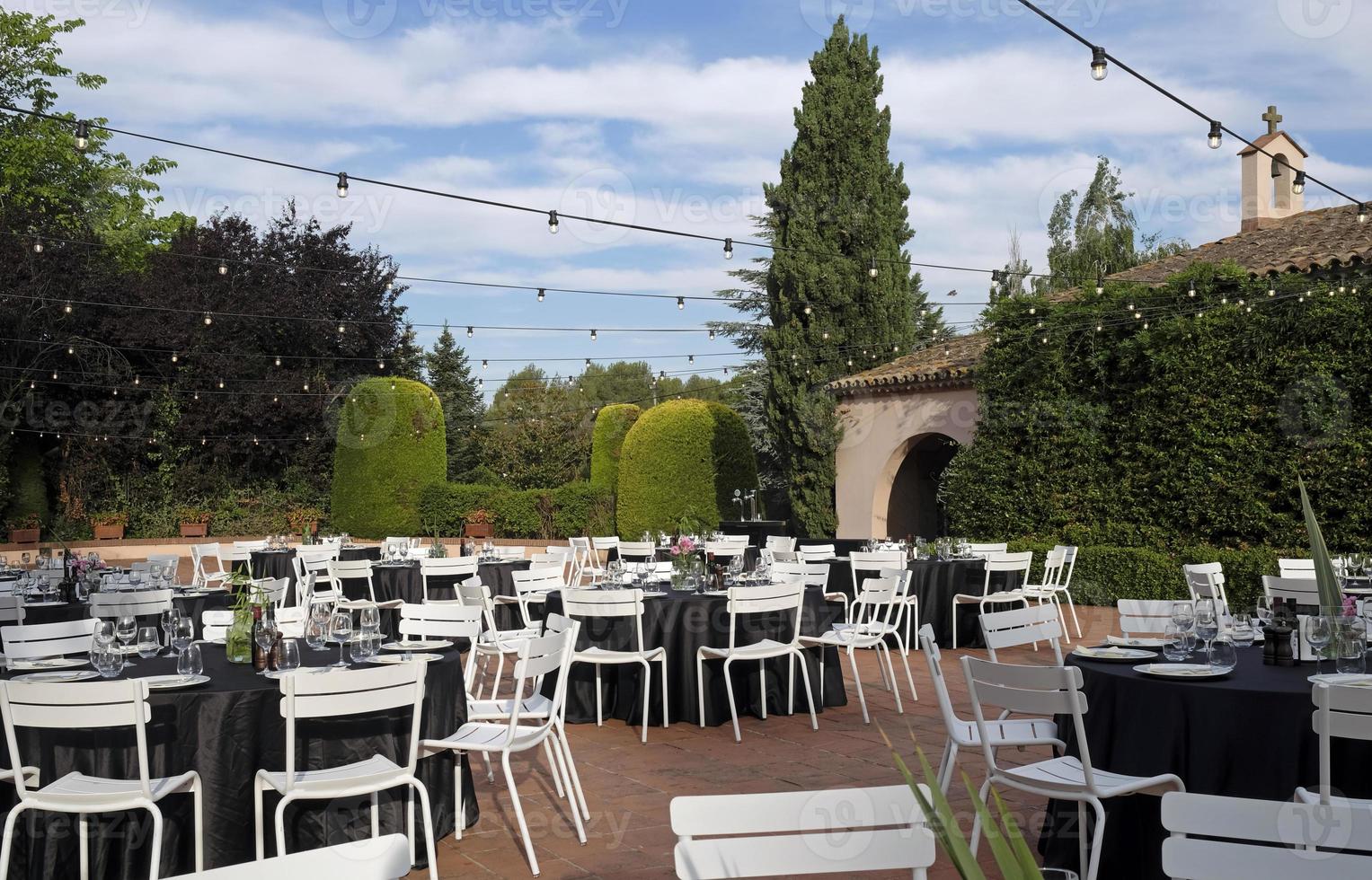 Outdoor venue with dinner tables before event photo