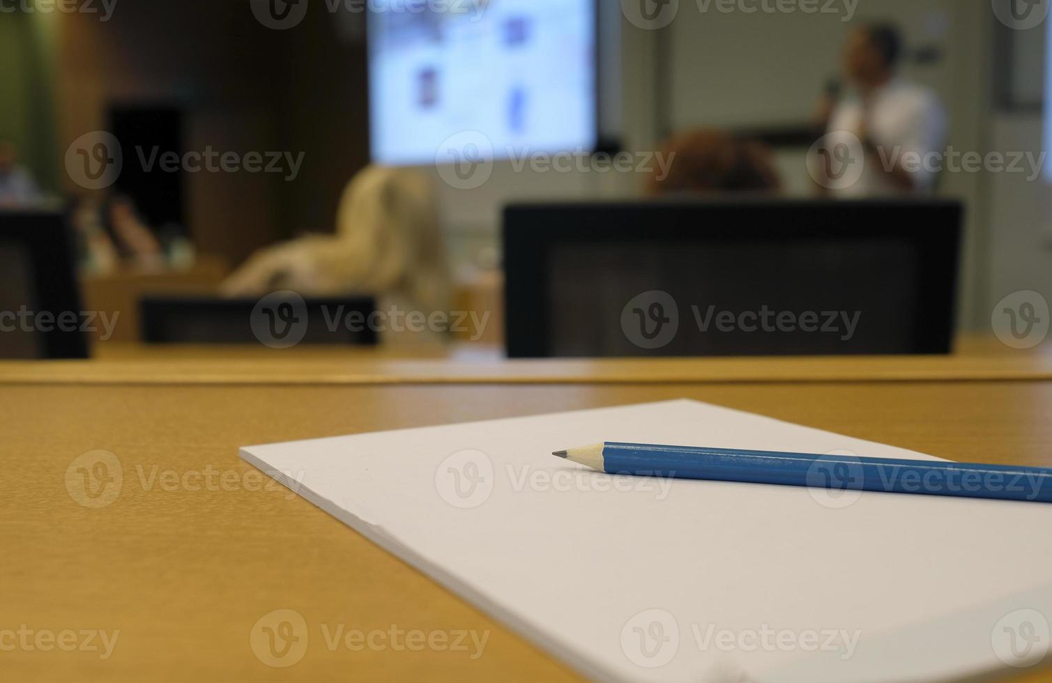 During a lecture or presentation - pen and paper in an auditorium photo