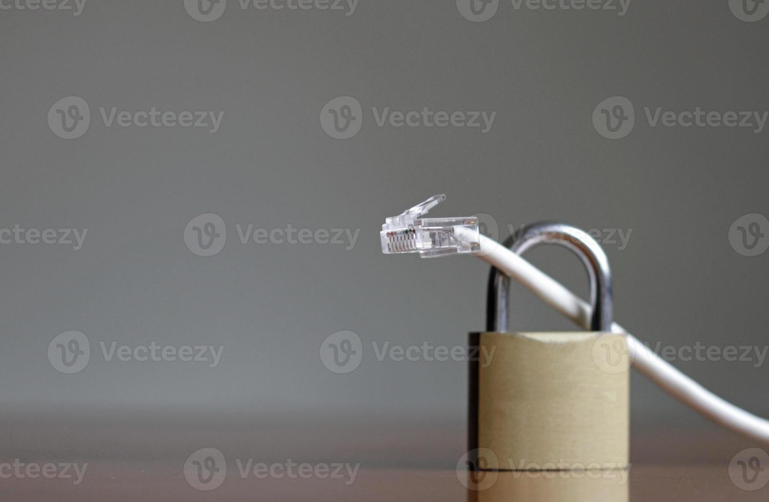 Network protection and secure access - network cable going through a padlock photo
