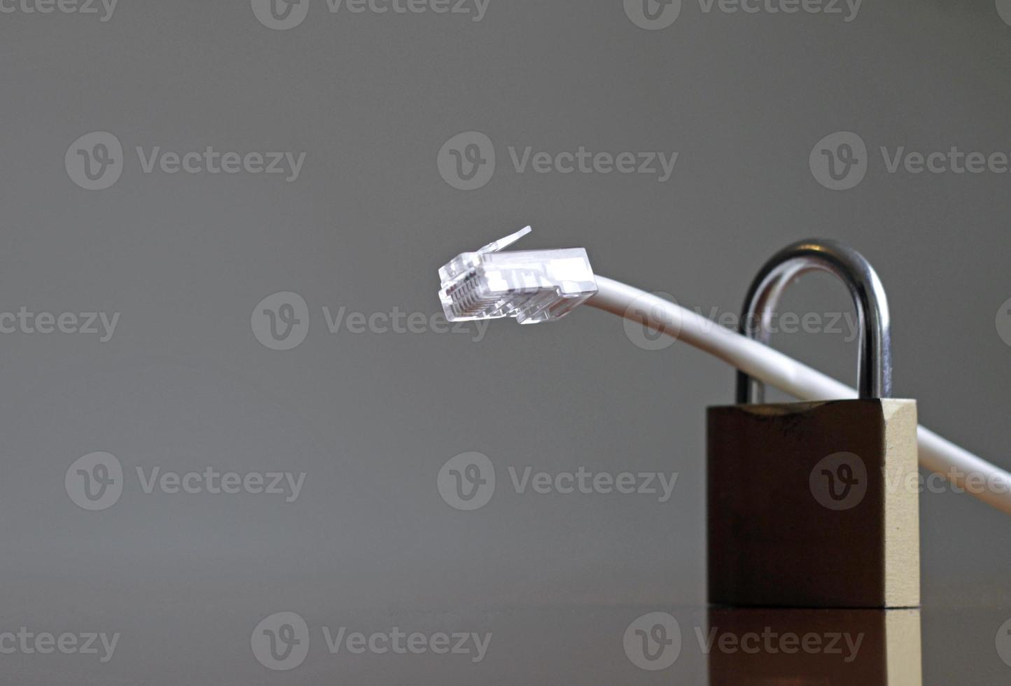 Network protection and secure access - network cable going through a padlock photo