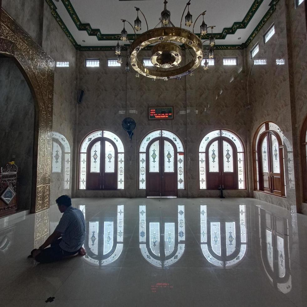 A photo of someone who is worshiping in the mosque