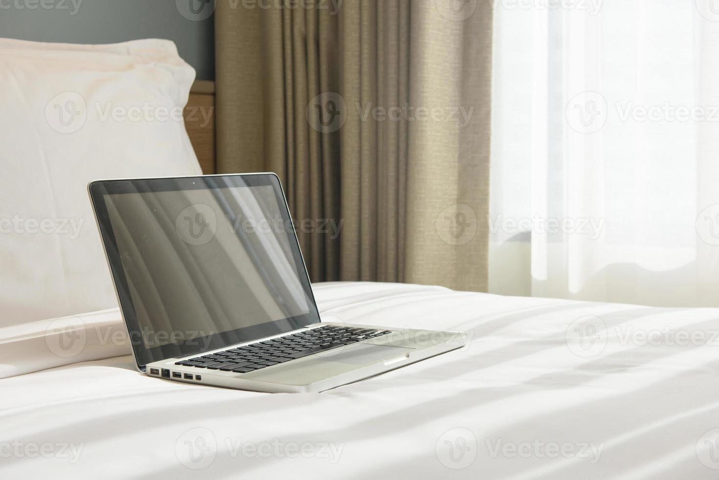 a laptop on a bed 11550777 Stock Photo at Vecteezy