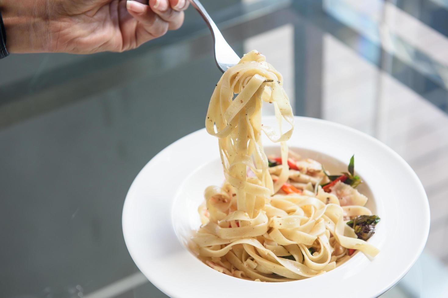 plate of pasta and hand man photo