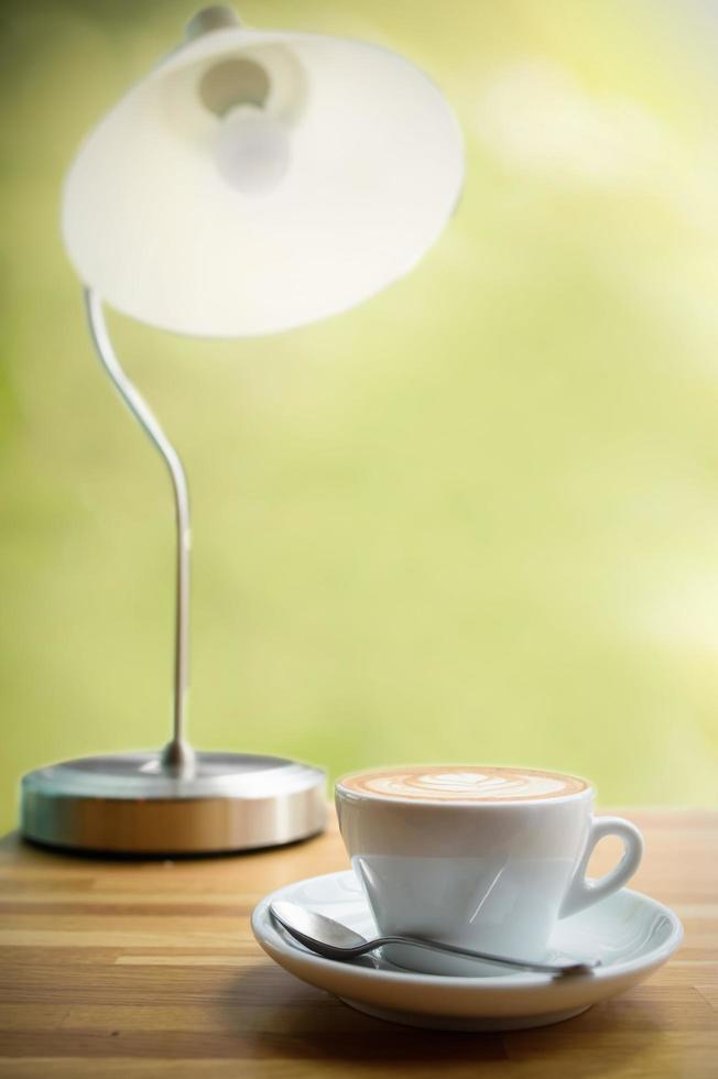 Wood table with lamp and coffee photo