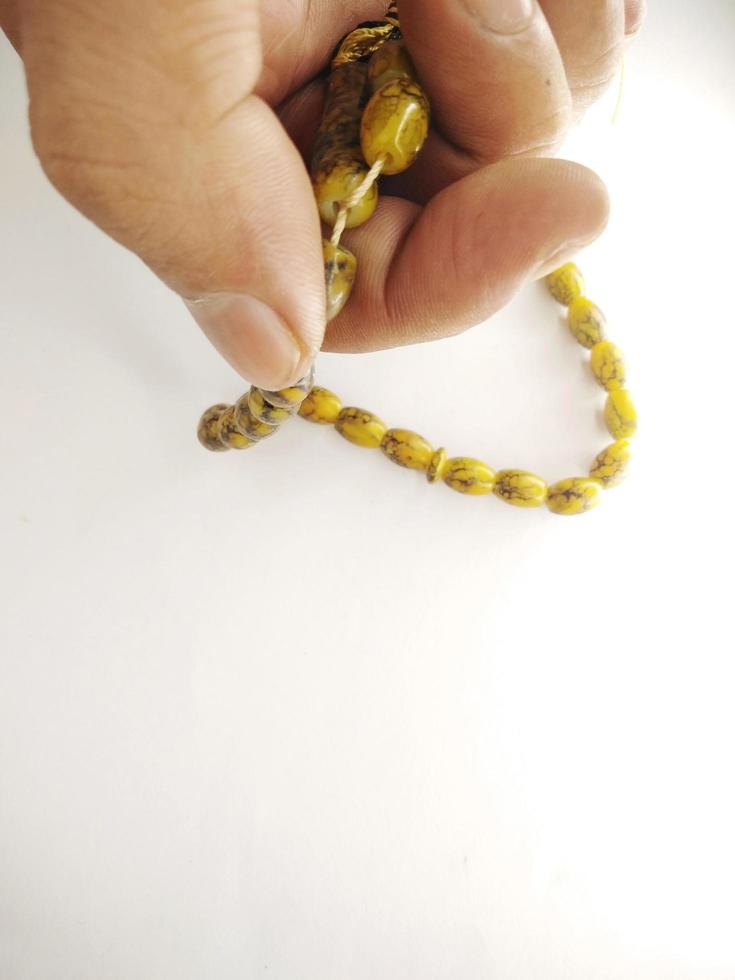 Round beads like marbles are often used for worship or after Muslim prayers, rosary beads isolated on white background. photo