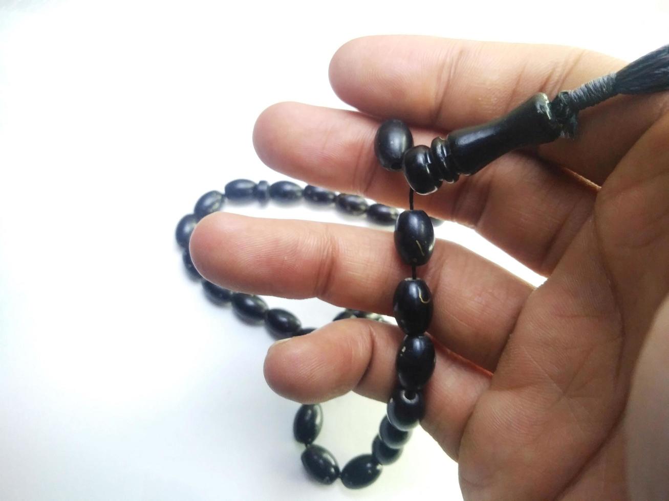 Round beads like marbles are often used for worship or after Muslim prayers, rosary beads isolated on white background. photo