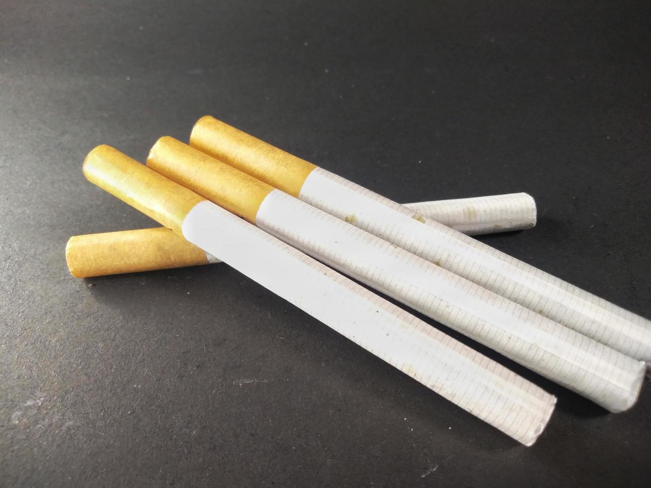 Cigarette on a black background.Bad habits.In the concept of stop smoking. photo