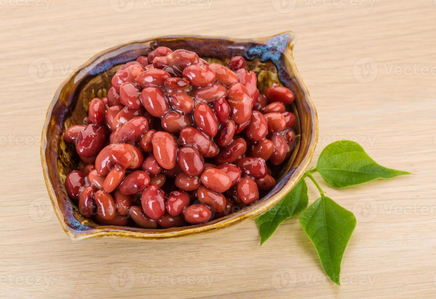 Red beans in a bowl on wooden background photo