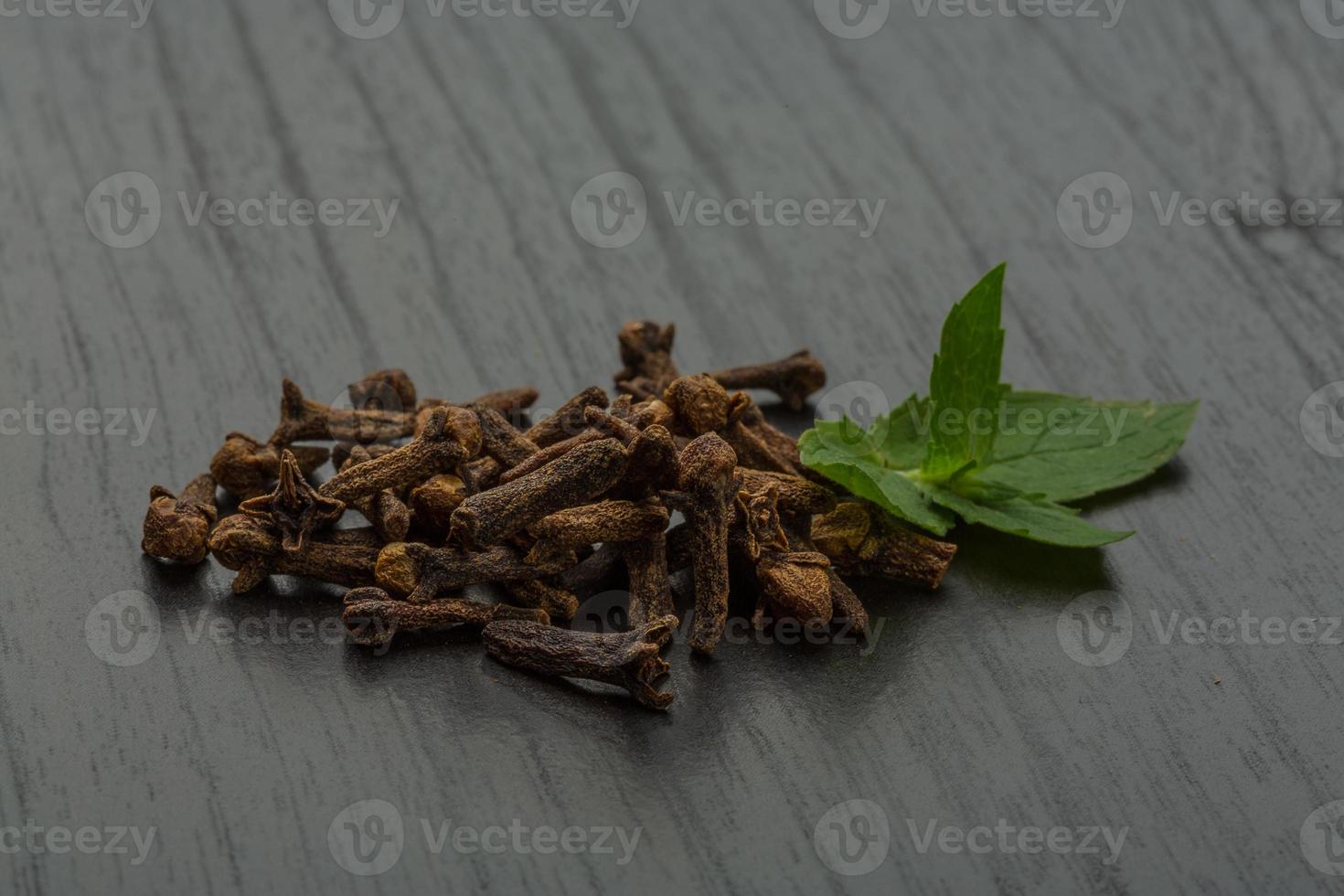 Clove seeds on wooden background photo