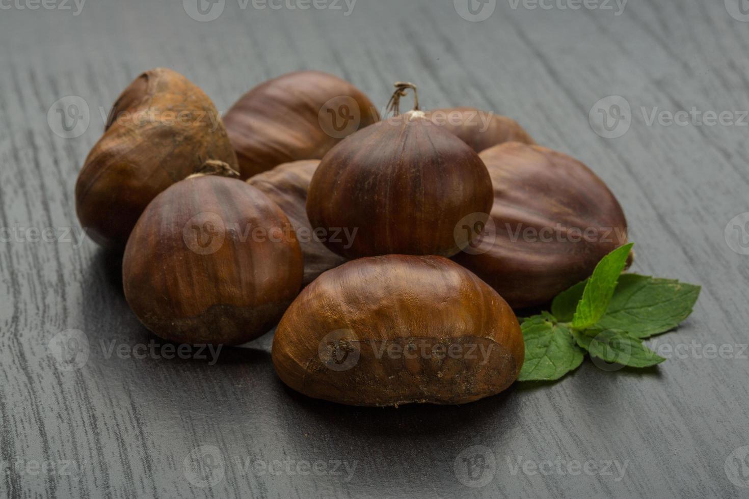 Chestnut on wooden background photo