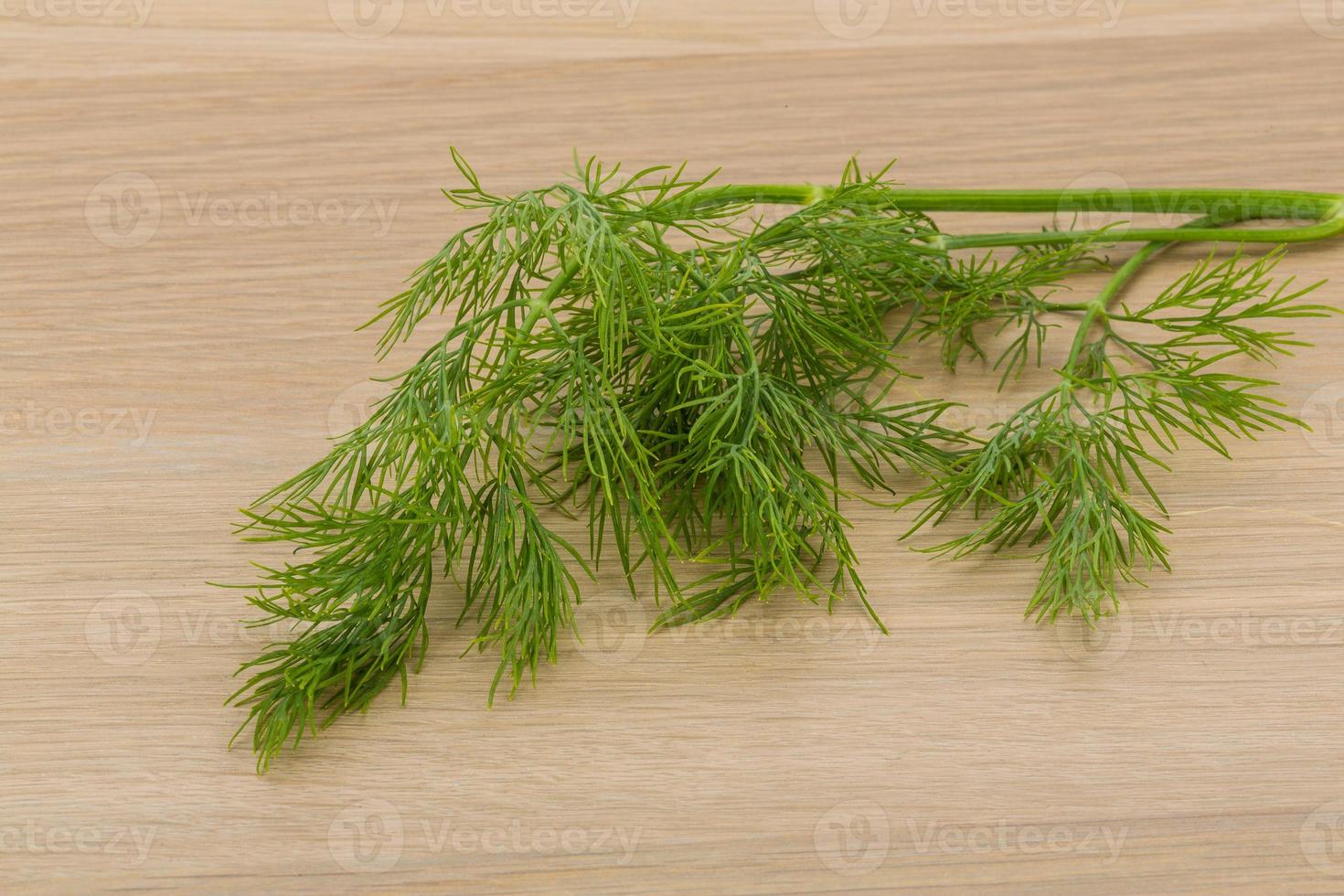 Dill on wooden background photo